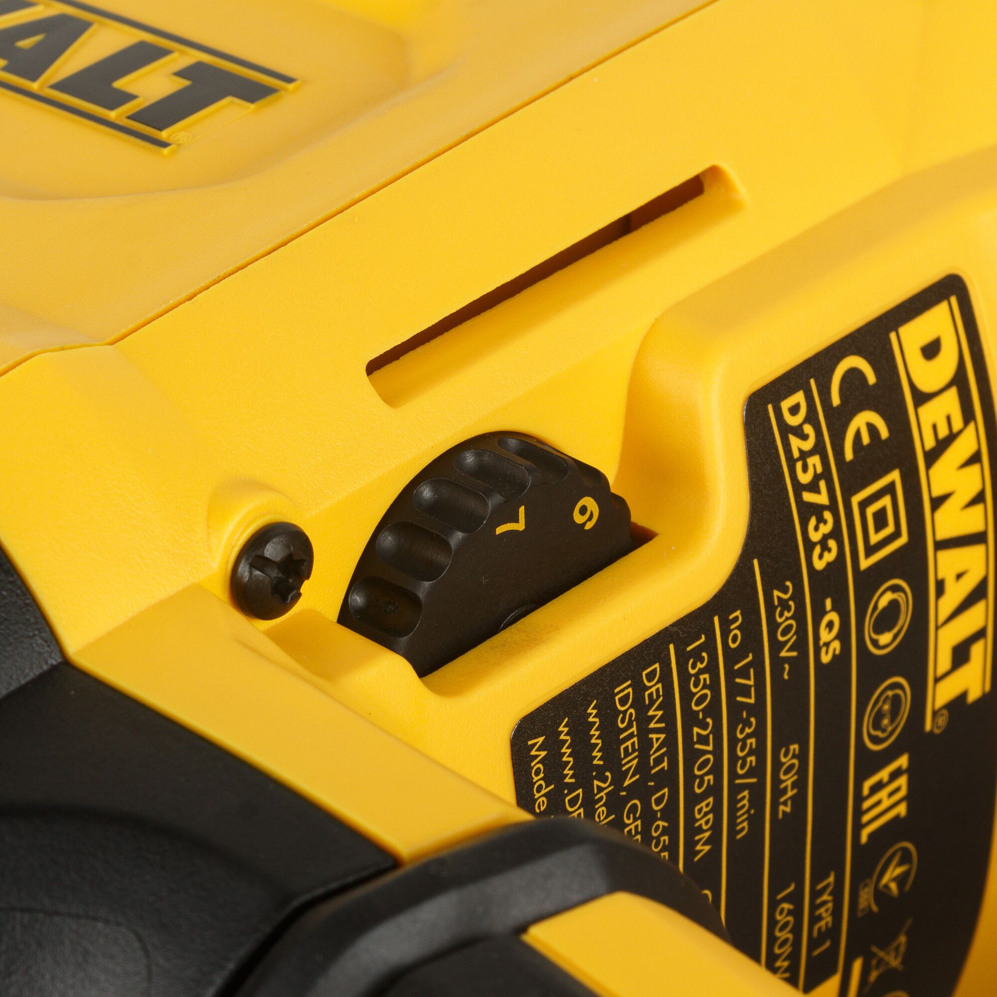 Close-up of a DEWALT electric tool, showing a detailed view of the model D25733K with control dial and technical specifications on a yellow body.
