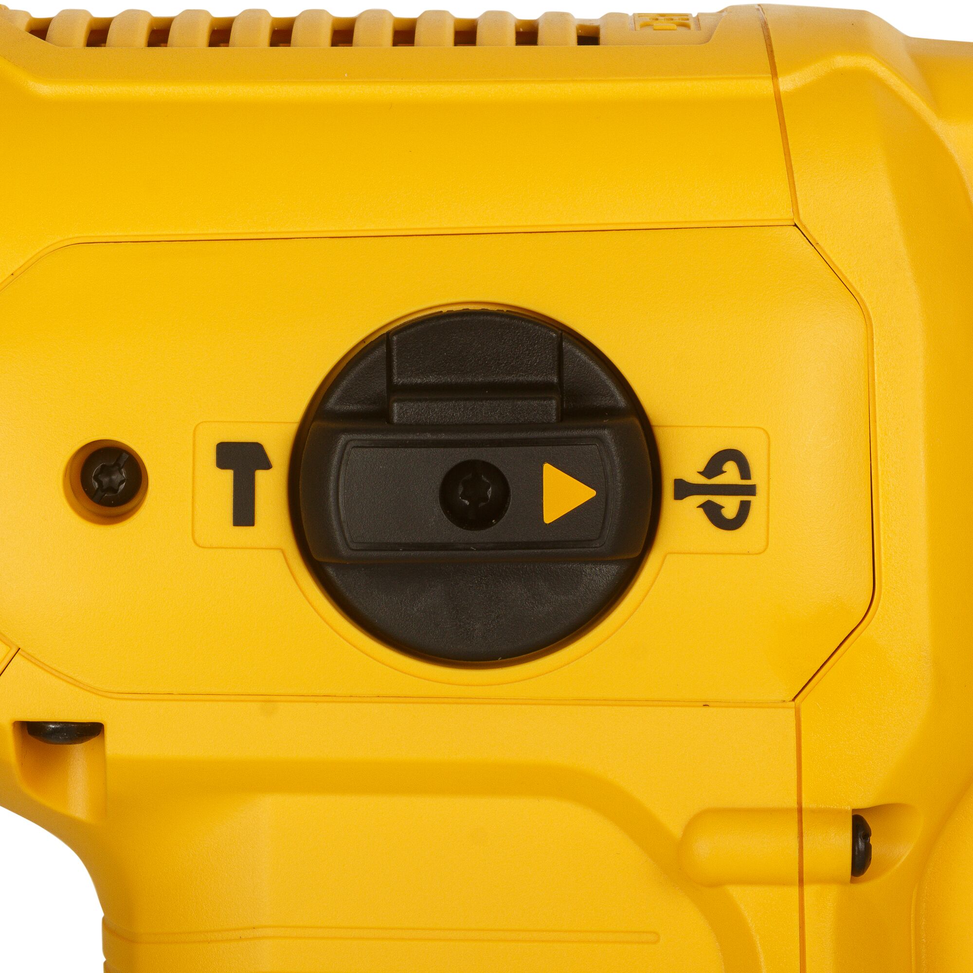 Close-up image of a yellow DEWALT tool showing a black circular mode selector switch with symbols for different functions, including chiseling and rotating modes.