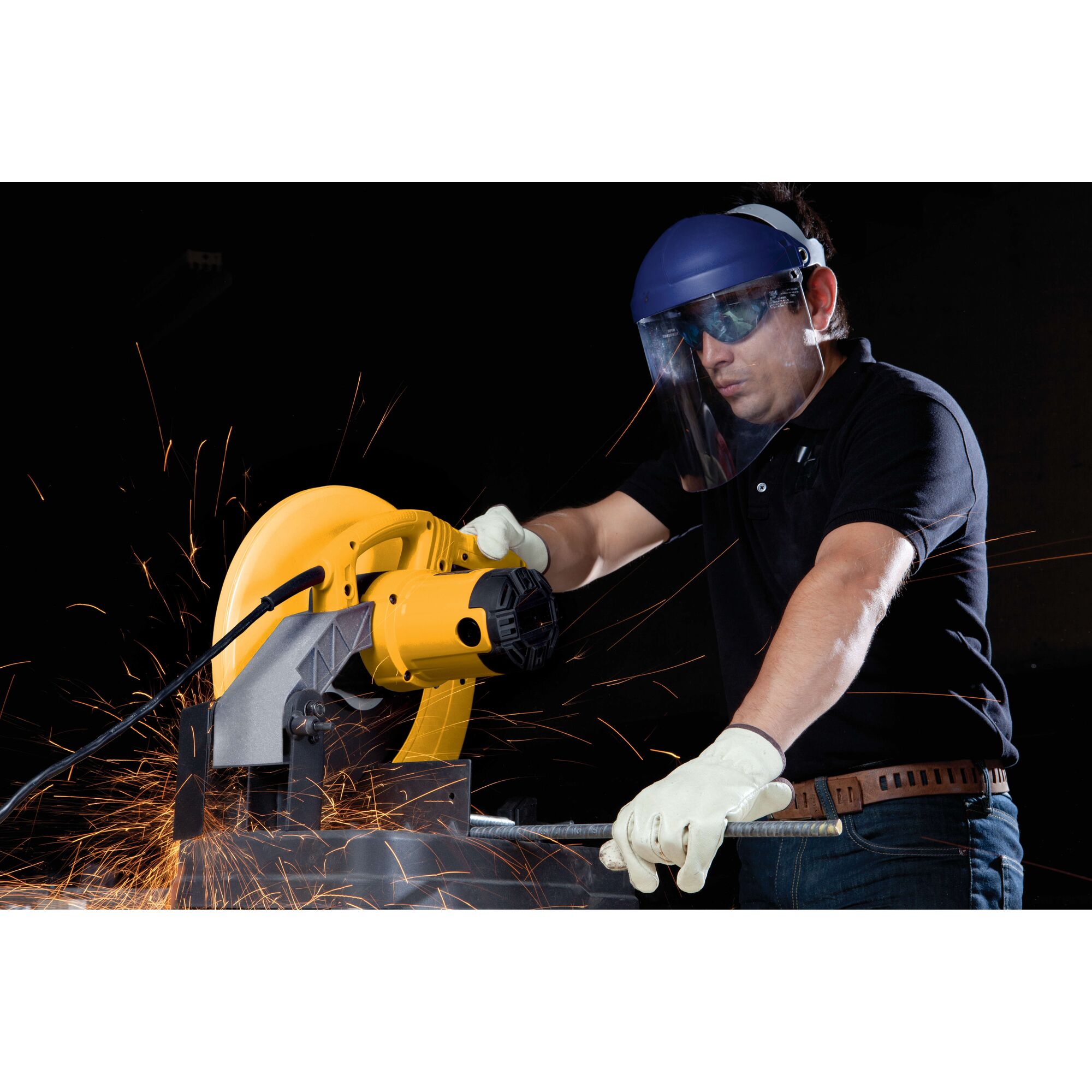 A person wearing safety gloves and a face shield is using a yellow DEWALT D28720 power tool to cut metal, with sparks flying during the process.
