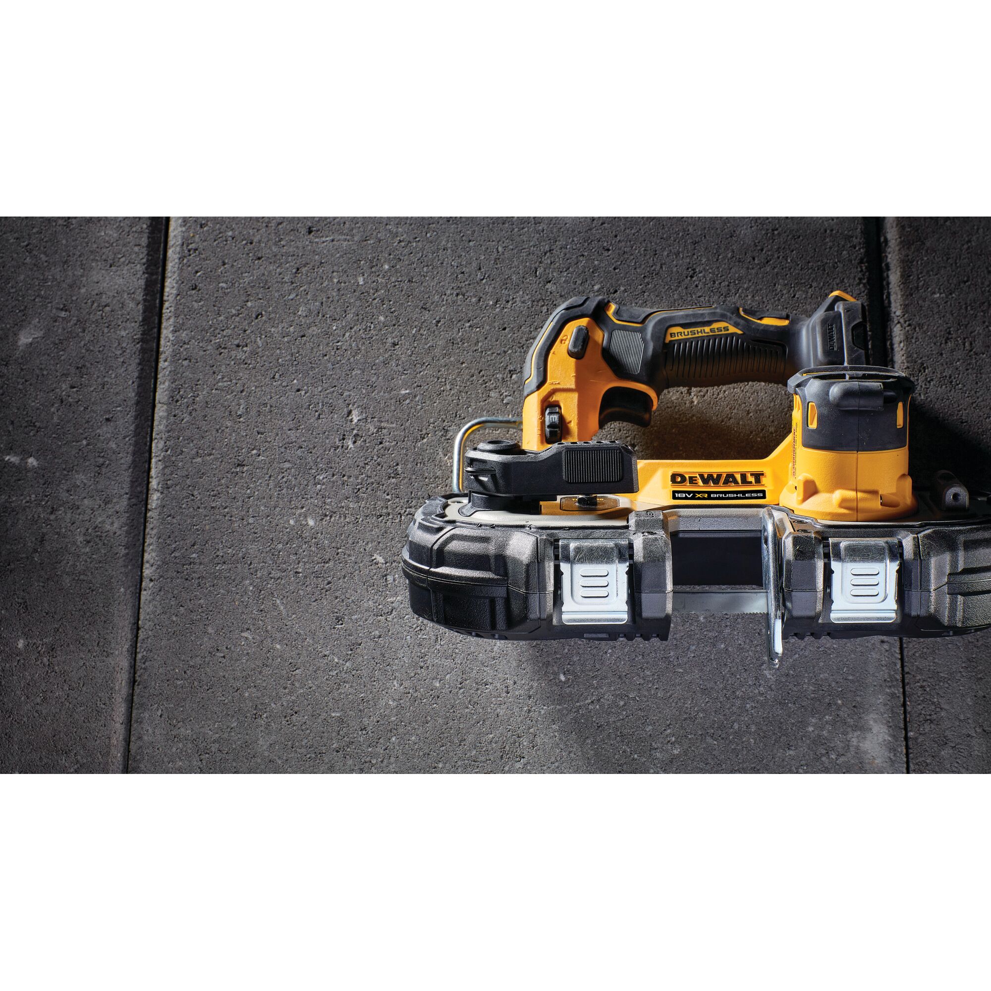 A yellow and black DEWALT cordless band saw, model DCS377NT, is shown placed on a concrete surface. The tool features a compact design and ergonomic handle.
