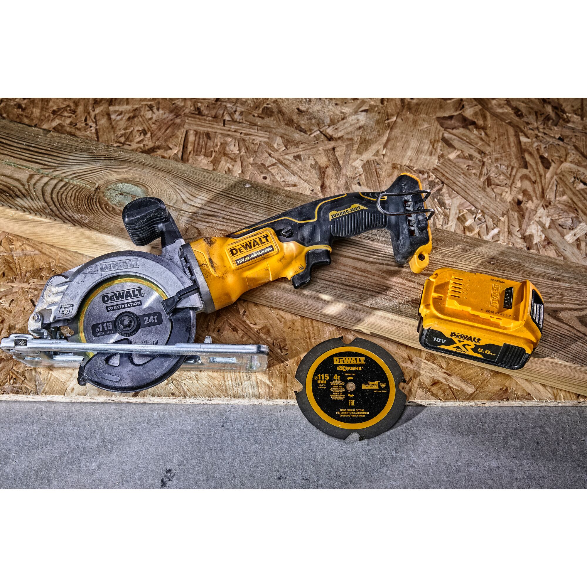DEWALT circular saw, battery, and extra blade set on wood surface. Construction tools and accessories shown.