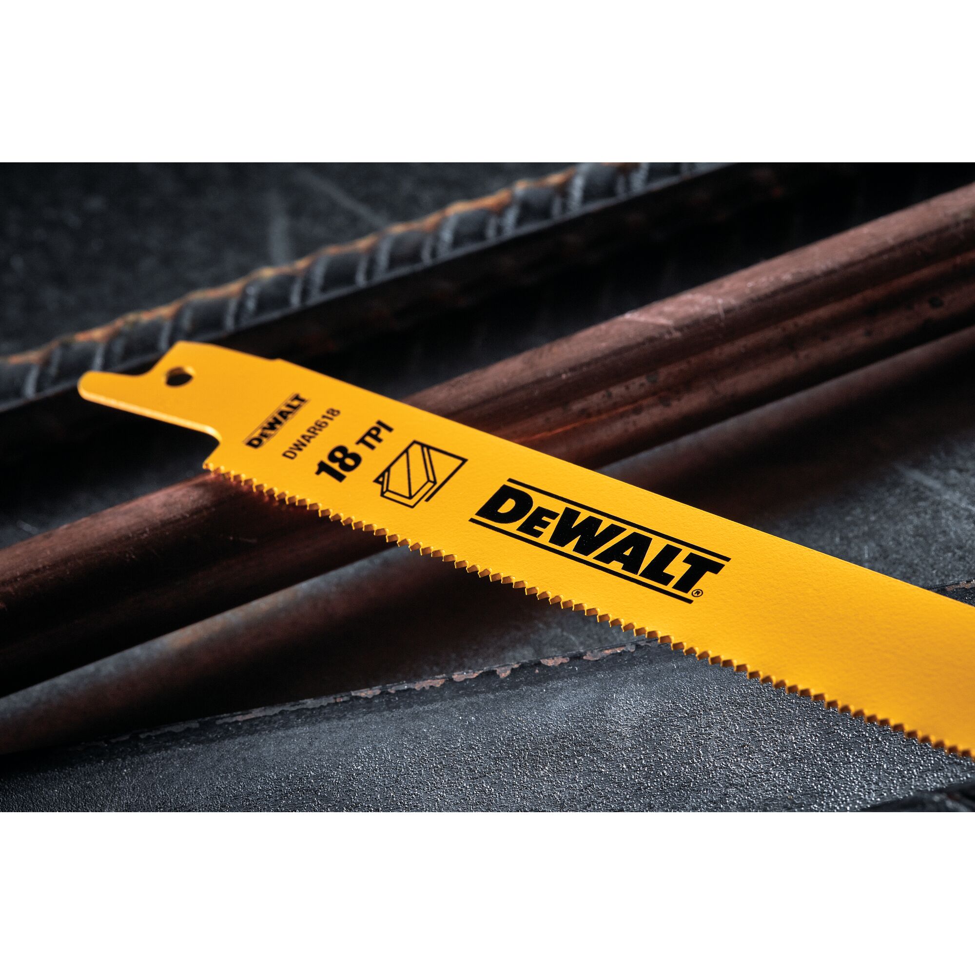 Close-up image of a yellow DEWALT reciprocating saw blade with '18 TPI' marking, placed next to metal rods.