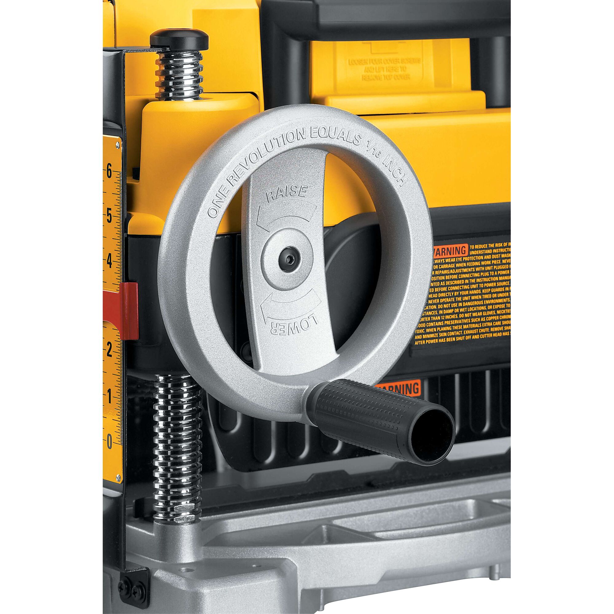 Close-up of the adjustment handle on a DEWALT DW735 planer, showing the metal hand wheel with 'Raise' and 'Lower' labels and measurement markings, along with yellow and black components.
