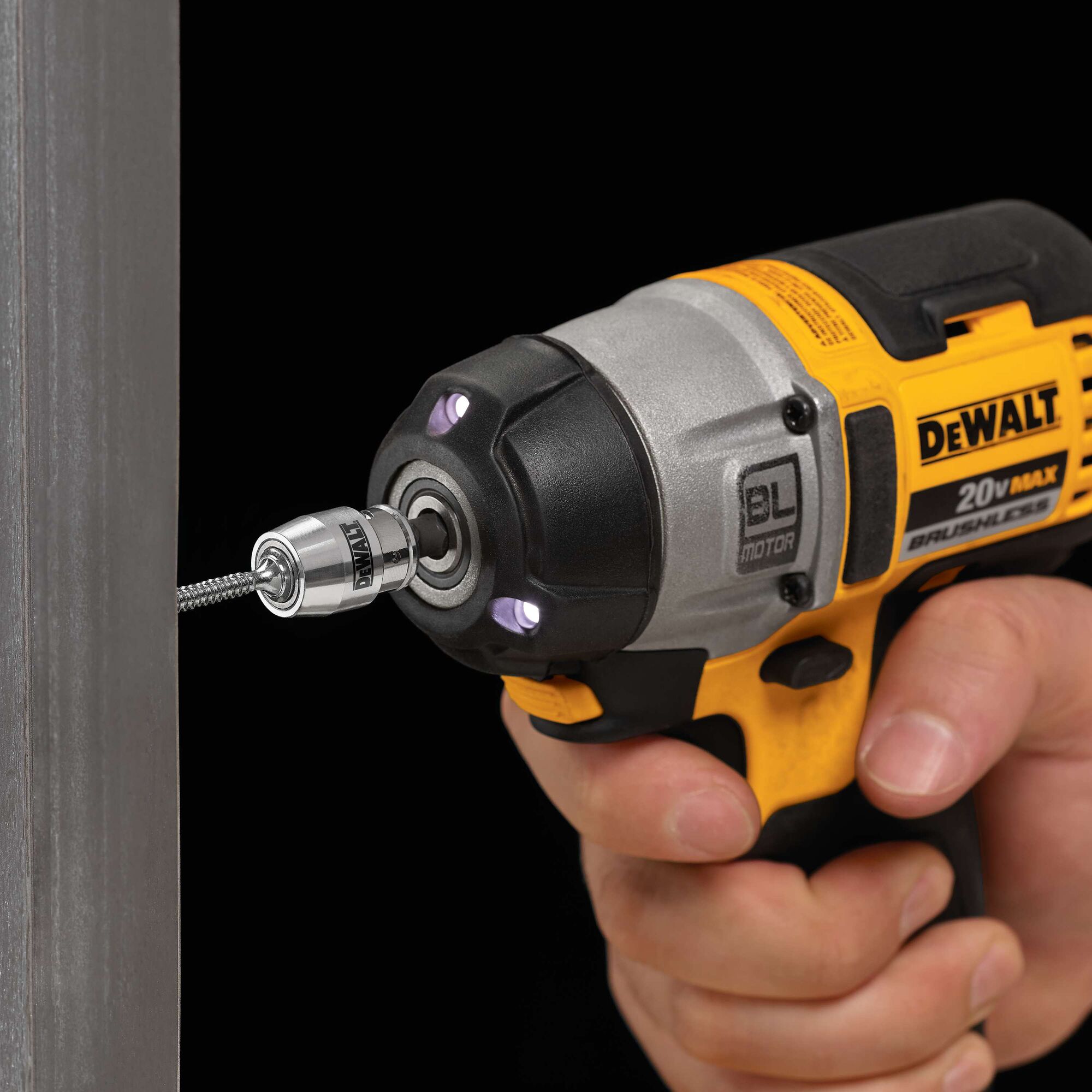 A close-up of a DEWALT 20V MAX brushless cordless impact driver in use. The tool is being used to drive a screw into a metal surface, with the DEWALT logo clearly visible on the tool's side.