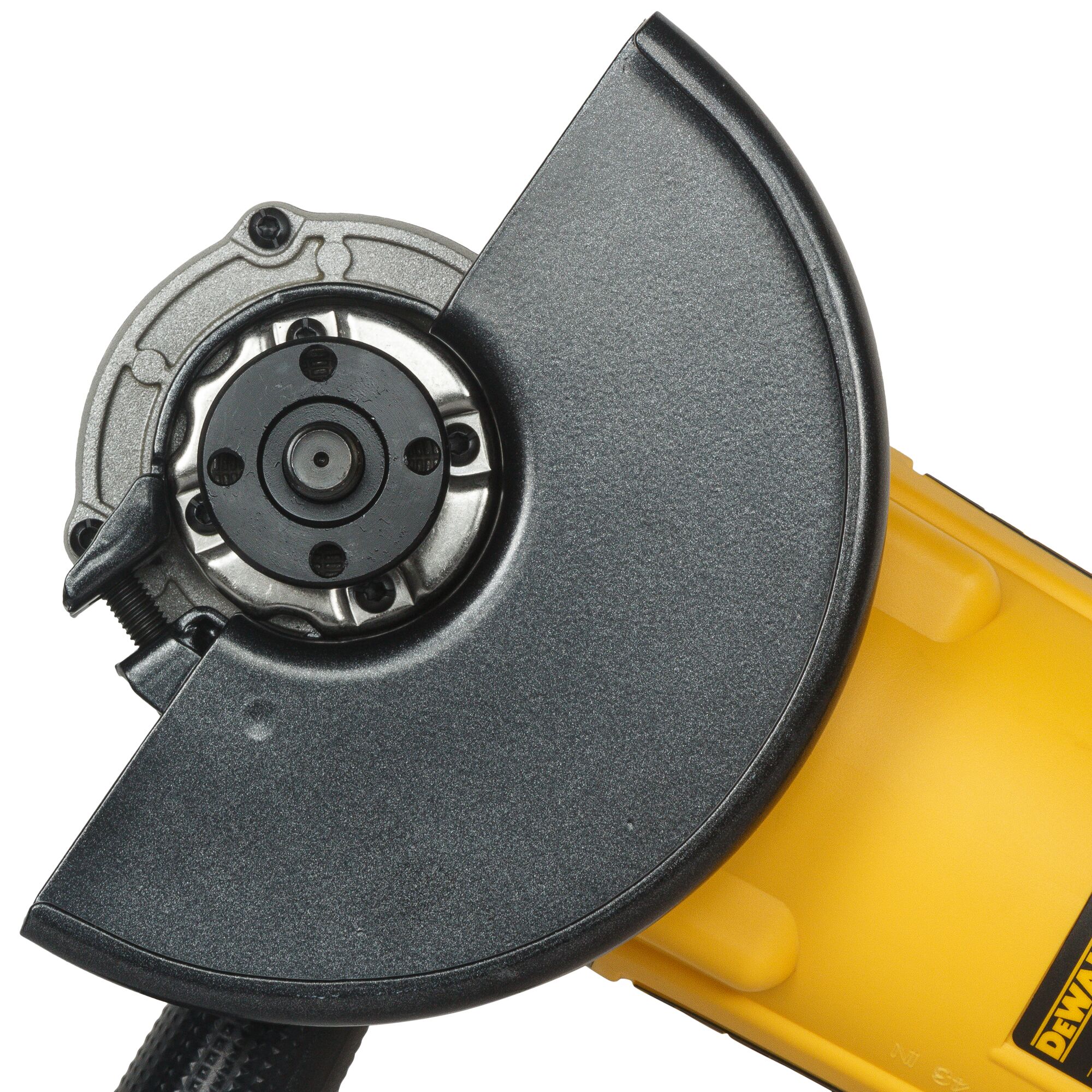 Close-up view of a DEWALT DWE497 angle grinder with a black protective guard and yellow body, showing the disc mount and part of the tool casing.