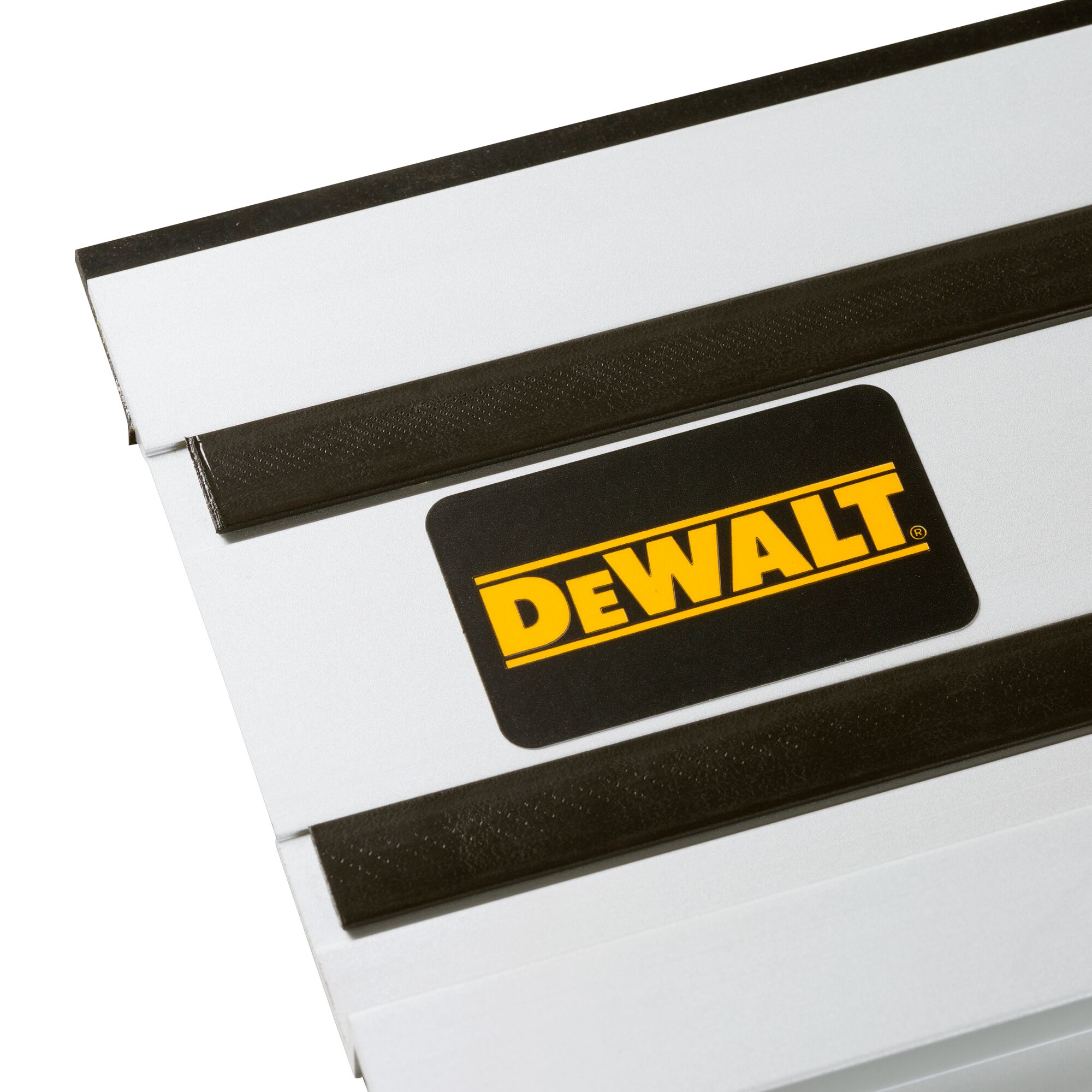 Close-up of a DEWALT branded metal guide rail with black strips, used as an accessory for power tools.